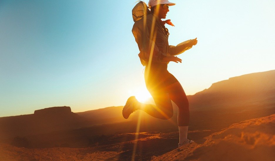 Hiker running along a desert ridge at sunset in Merrell Speed Strike 2 shoes